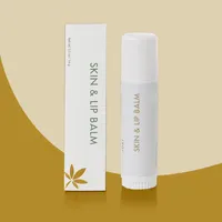 View: Slim white custom lip balm box standing next to a matching white twist-up lip balm tube