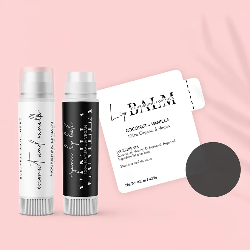 Two lip balm tubes in white and black next to a printed vanilla lip balm label showing an ingredient panel