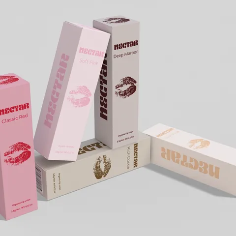 A range of pink and nude lip care cartons standing and lying together with matching printed panels