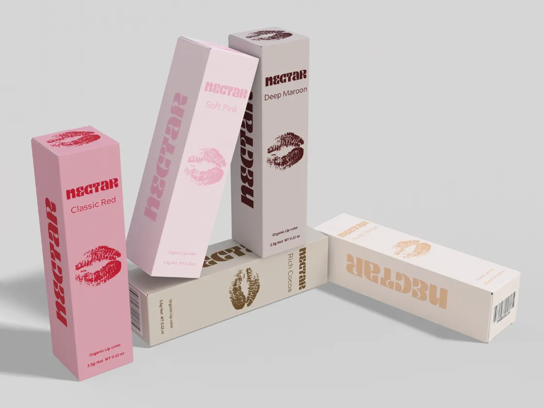 A range of pink and nude lip care cartons standing and lying together with matching printed panels