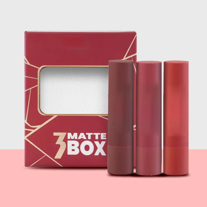 Dark red three-pack lipstick box with a wide window and gold line artwork beside three matte lipstick cases