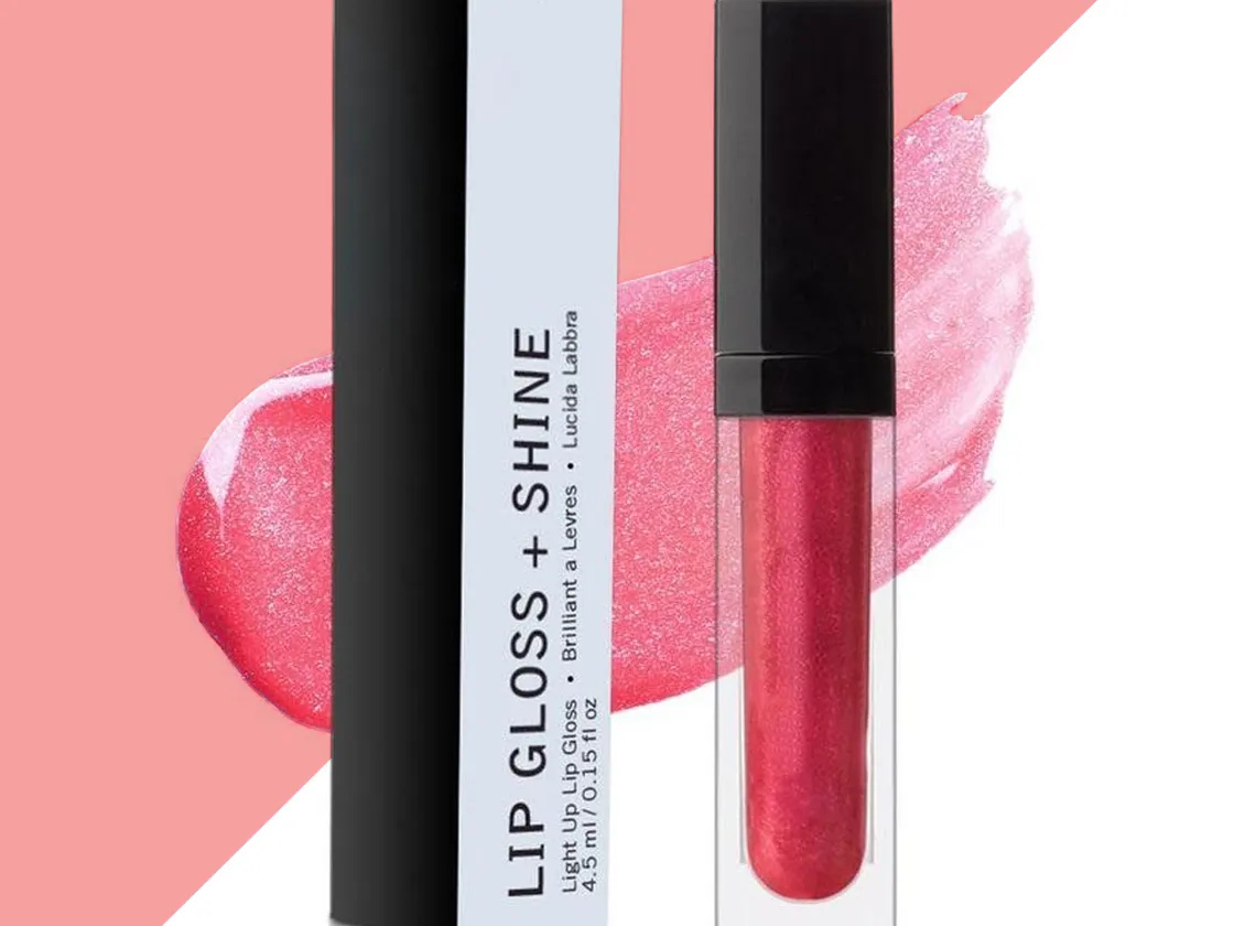 Tall slim black and white lip gloss box standing beside a clear gloss tube with a black cap