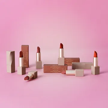 A collection of nude and terracotta lipstick boxes with matching lipstick cases