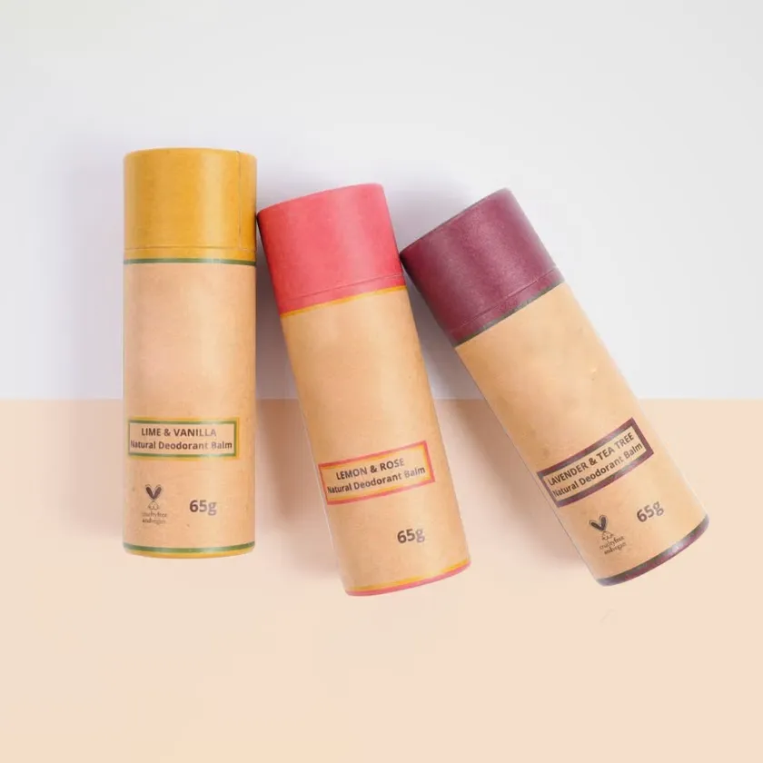 Three larger format paperboard balm sticks in yellow, pink and mauve with printed ingredient panels