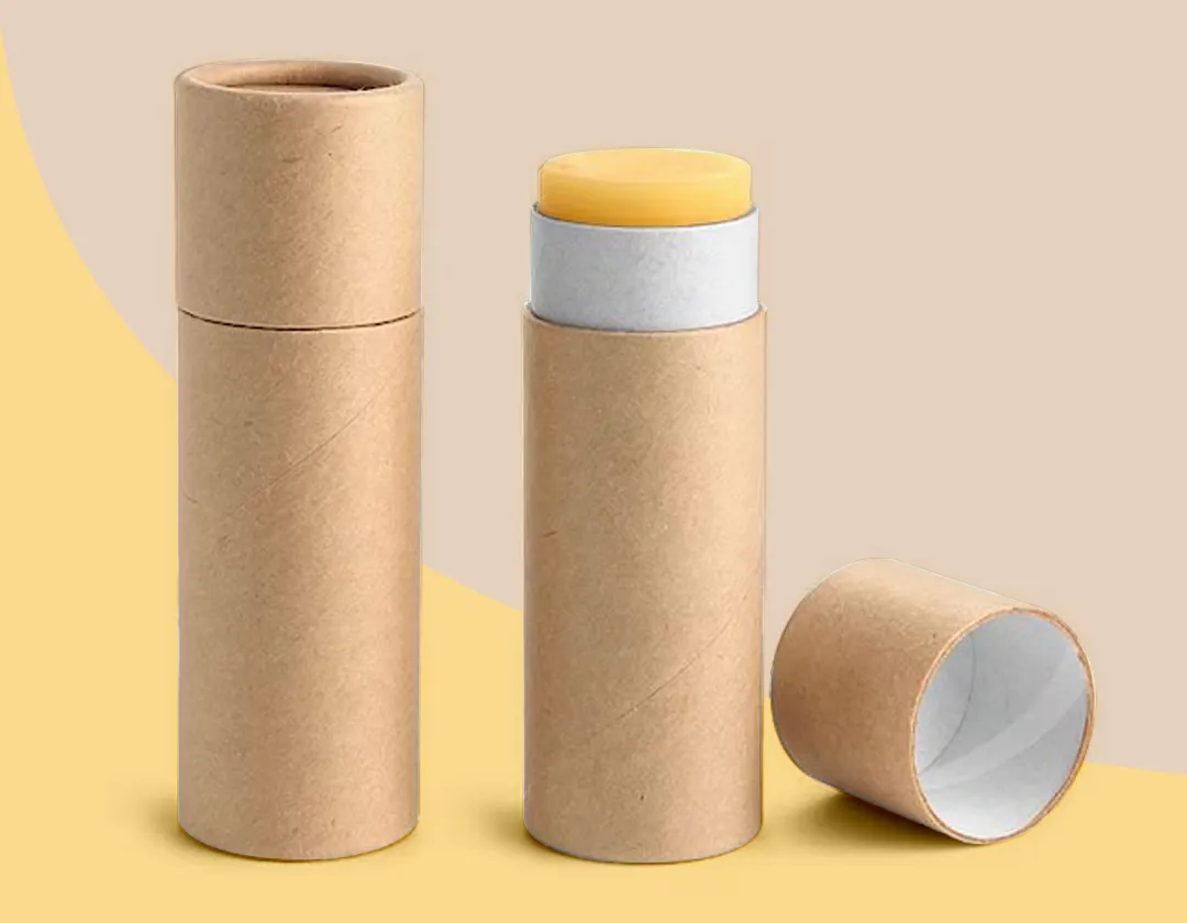 Three natural kraft paper lip balm tubes, one open showing the inner liner and push-up base